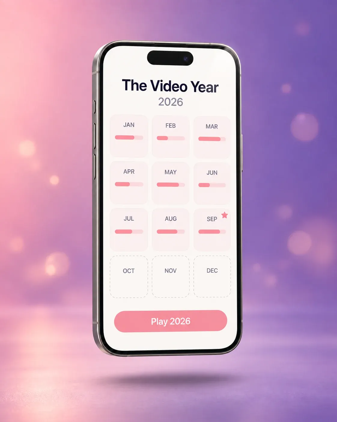The Video Year board in DearBaby: a phone showing 2026 as twelve month tiles, each recorded month holding a small clip bar, the last three still empty, above a Play 2026 button